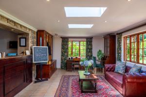 a living room with a couch and a table at Walkersons Hotel & Spa in Dullstroom