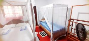 Postel nebo postele na pokoji v ubytování Bamboo Home stay Hiriketiya