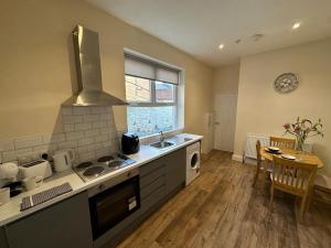 a kitchen with a sink and a stove top oven at The Westlands Apartment High Barnes Sunderland in Pallion