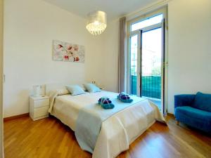a bedroom with a bed and a blue couch at Tramonto sul Mare - Sea Suite in Savona +92 photos
