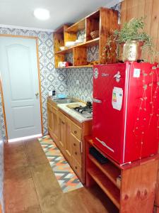a kitchen with a red refrigerator and a stove at Cabaña Totoralillo in Coquimbo