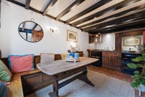 a living room with a table and a couch at 15th century tiny character cottage-Henley centre in Henley on Thames