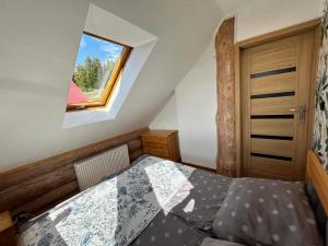 a small bedroom with a bed and a window at Pod Smrekami in Sól +49 photos