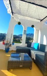 a living room with a couch and a table at Happy Holiday Home! Pueblo Evita Charming Condo in Benalmádena