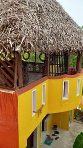 a model of a house with a straw roof at Squirrel Nest Guest House in Mahabalipuram