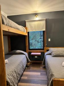two bunk beds in a room with a window at Inspiramide Pucon in Pucón