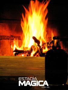 un fuego en un horno de ladrillo con llamas en Hotel Termas Lahuen-Có en Los Molles