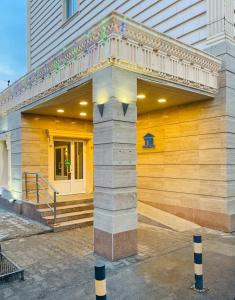 a building with a balcony on the side of it at Tengri Hotel in Atyrau