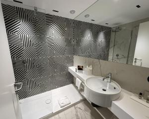 a bathroom with a sink and a mirror at Valentino Resort in Grottammare