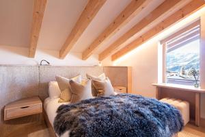 a bedroom with a couch and a window at La Ruinette- Stylish 4-bed, Centre Of Verbier in Verbier