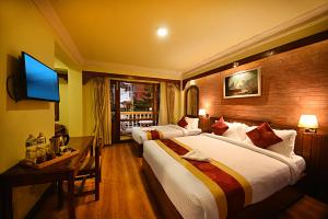 Ένα ή περισσότερα κρεβάτια σε δωμάτιο στο Nirvana Boutique Hotel
