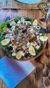 a bowl of salad with eggs on a table at Panorama ait Hani Tinghir in Tinerhir