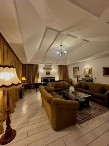 a large living room with couches and a table at Amrouss touristic DarMaroc in Azrou