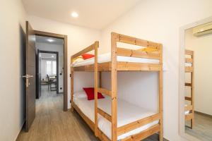 a room with two bunk beds and a hallway at Luxury Beach Apartment, next to the sea in Premiá de Mar