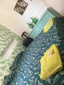 a bedroom with a bed with a blue comforter at Residencia La Isabel in San Luis