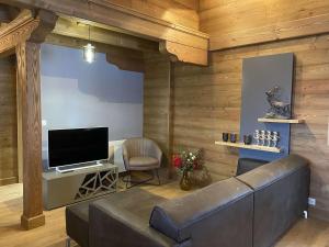 a living room with a couch and a flat screen tv at Chalet Hauteluce, 4 pièces, 7 personnes - FR-1-342-309 in Hauteluce
