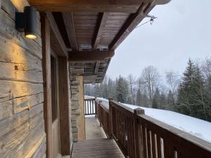a porch of a log cabin with snow on the trees at Chalet Hauteluce, 4 pièces, 7 personnes - FR-1-342-309 in Hauteluce