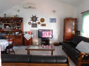 a living room with a couch and a table at Holiday House Rivi in Milna