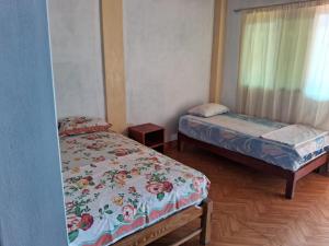 a room with two beds and a window at Dylan Beach in Zorritos