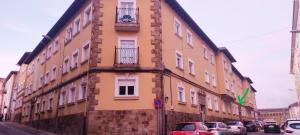 a building with cars parked in front of it at Apartamento La Luz de Reinosa 3 in Reinosa