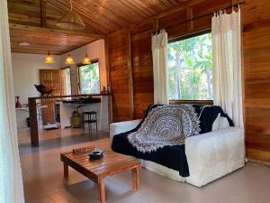 a living room with a couch and a table at Cabana das Mandalas in Itacaré