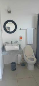 a bathroom with a toilet and a sink and a mirror at Casa Linda - Habitacion Puerto Morelos-Cancun-Playa Del Carmen in Puerto Morelos