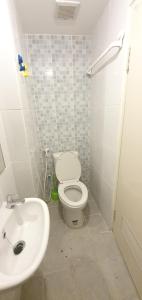 a bathroom with a white toilet and a sink at Tokyo Riverside Apartment Studio at PIK2 in Gedong +6 photos