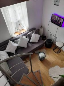 a living room with a couch and a window at Knez Mihailova apartment - City Center in Belgrade