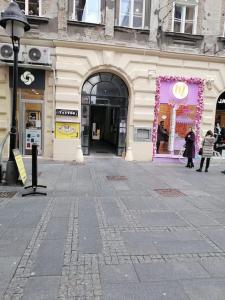 a building with a store front with a purple display at Knez Mihailova apartment - City Center in Belgrade