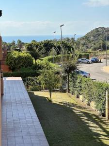 een stenen loopbrug met bomen en een parkeerplaats bij Casares del Sol penthouse with private roof terrace 80m2 in Bahia de Casares
