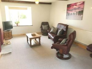 a living room with two chairs and a tv at Hayfellside Cottage, Sleep 6,3 Bedrooms(1 ensuite) in Kendal