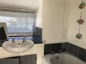 a bathroom with a sink and a bath tub at Hayfellside Cottage, Sleep 6,3 Bedrooms(1 ensuite) in Kendal