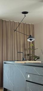 a black lamp sitting on top of a dresser at Modern Seafront Villa Steps from the Beach in Rogoznica