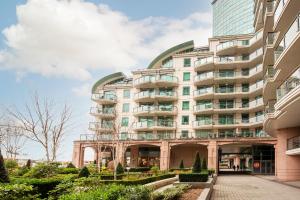 a large building with a walkway in front of it at Terraced riverview apartment in London