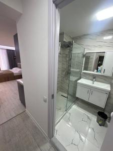 a bathroom with a shower and a sink at Hotel Peak in Gudauri +11 photos