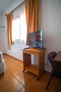 a desk with a laptop on it in a room with a window at Apart hotel la Trejo in San Pedro Sula