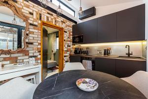 a kitchen with a table with a bowl on it at Scarlett Heart Studios in Golders Green in London