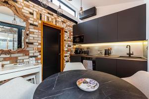 a kitchen with a table with chairs and a counter at Scarlett Heart Studios in Golders Green in London