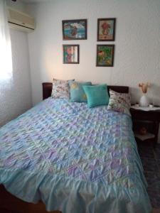 a bedroom with a bed with a colorful comforter at Oplenacki smestaj Milica in Topola