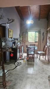 a living room with a table and a dining room at Residencia monica in Capilla del Monte