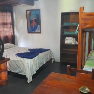 a bedroom with a bed and a book shelf at Cabañas Gesell in Villa Gesell