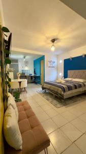 a bedroom with a bed and a living room at Suites Brisa Marina - Playa Regatas y Malecón in Veracruz