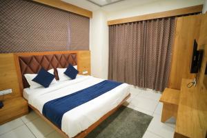 Postel nebo postele na pokoji v ubytování Hotel Suncity