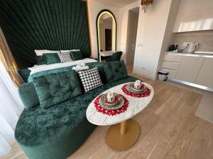 a living room with a green couch and a table at Belgrade Waterfront Luxury Apartment in Belgrade