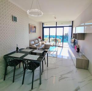 a kitchen and living room with a table and chairs at Sunset Drive Apartments in Benidorm