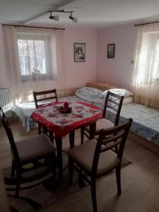 a room with a table and chairs and a bed at Lovely studio in Dragoman with garden and garage in Dragoman