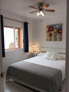 Schlafzimmer mit einem Bett und einem Deckenventilator in der Unterkunft Apartamento en Puerto de Mazarrón in Puerto de Mazarrón