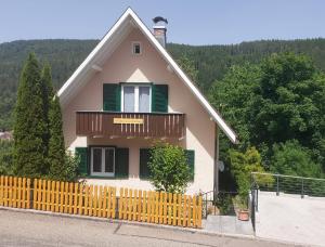 a house with a wooden fence in front of it at Ferienhaus Barbey in St. Blasien