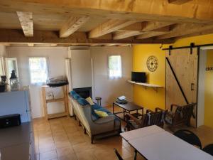 a living room with a couch and a table at Le Mas de Sorias in Fossemagne