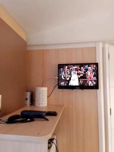 a television hanging on a wall in a room at Camping, mobil home équipé proche du lac de Sainte Croix et des gorges du Verdon in Sainte-Croix-de-Verdon